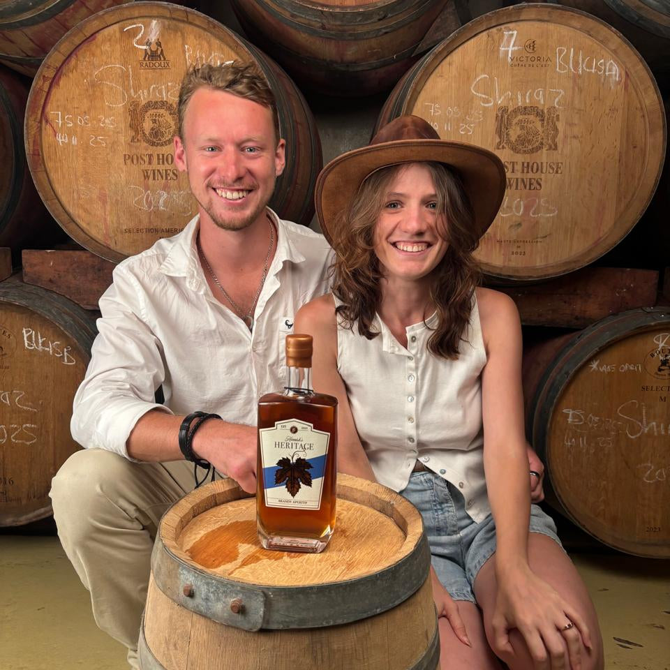 Hamish Gebers and Mel with a bottle of heritage